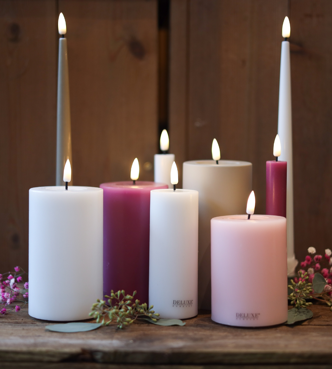 Deluxe Homeart LED-Kerzen in den Farben weiß und rosa.